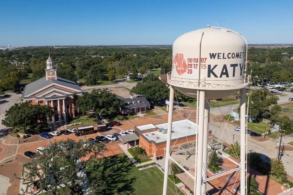 Katy water tower overlooking downtown streets and a columned civic building