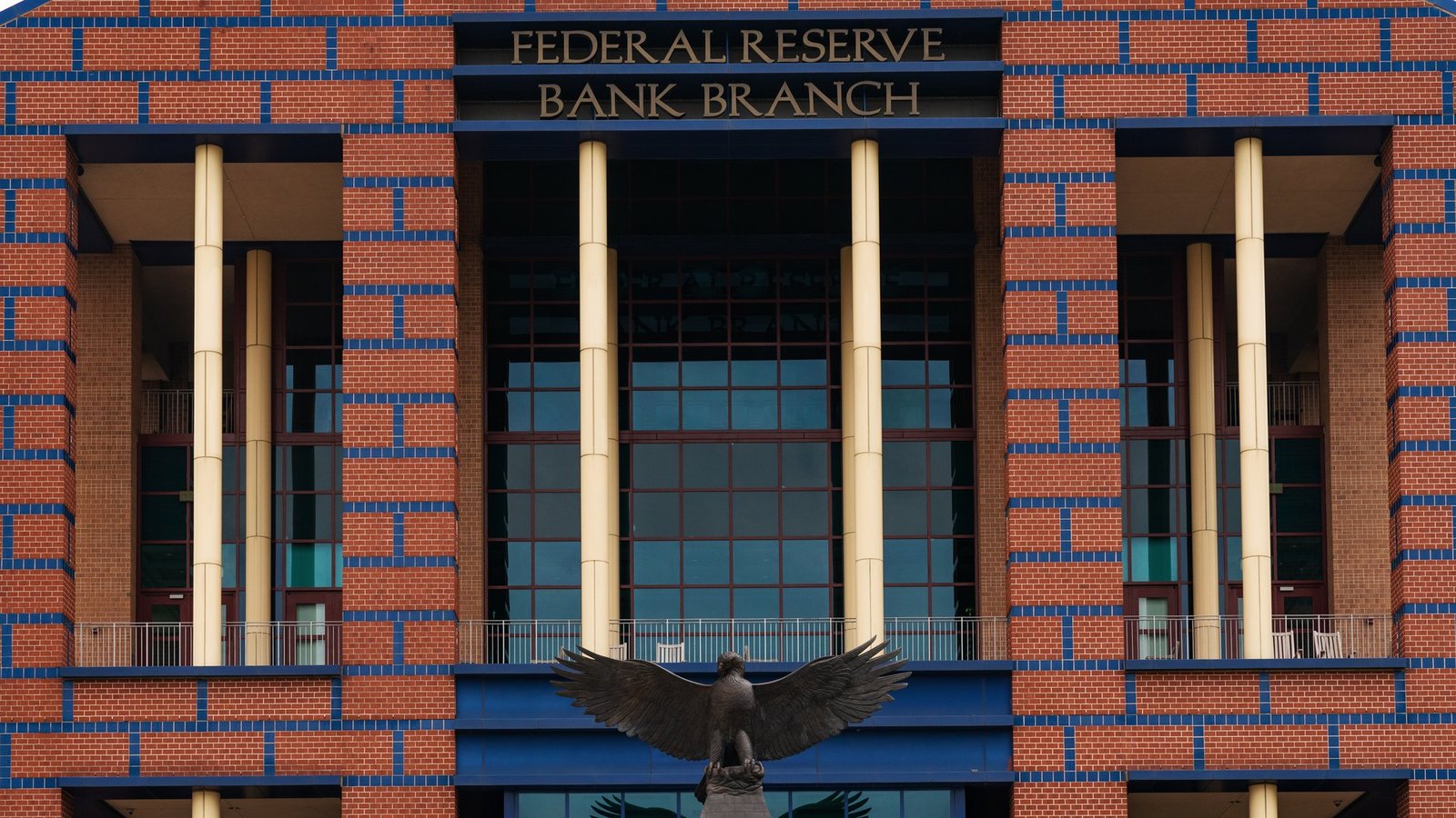 The brick and glass front of the Federal Reserve Bank branch building on Allen Parkway in Houston